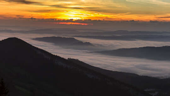 Finding Our Way From Struggle to Harmony in the Here and Now photo of a sunrise with fog in the valley below