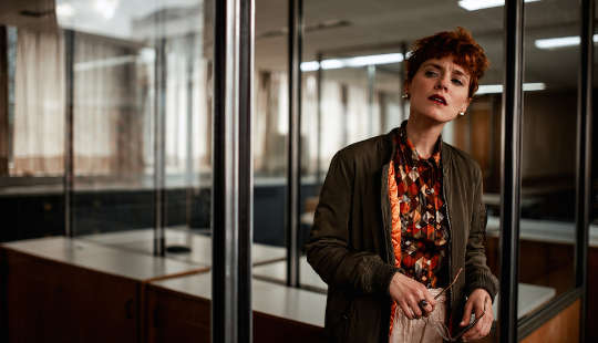 What to Do If You See or Hear Casual Racism or Sexism at Work concerned-looking woman standing in an office setting