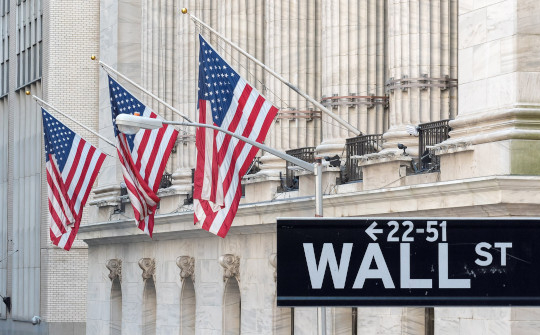 Making Dollars Count: Shifting Economic Focus from Quantity to Quality photo of wall street with American flags