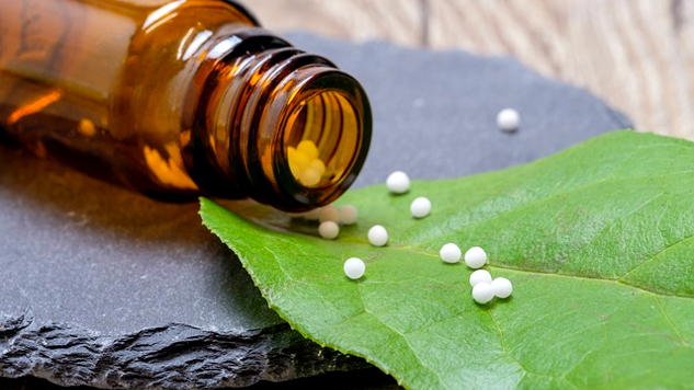 homeopathic globules poured out on a leaf